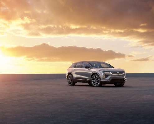 Front 3/4 view of 2025 Cadillac OPTIQ in Argent Silver Metallic.