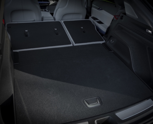View of the 2025 Cadillac OPTIQ rear cargo area with rear seats folded flat.